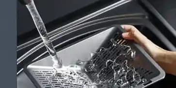 The V937 filter being washed under a tap
